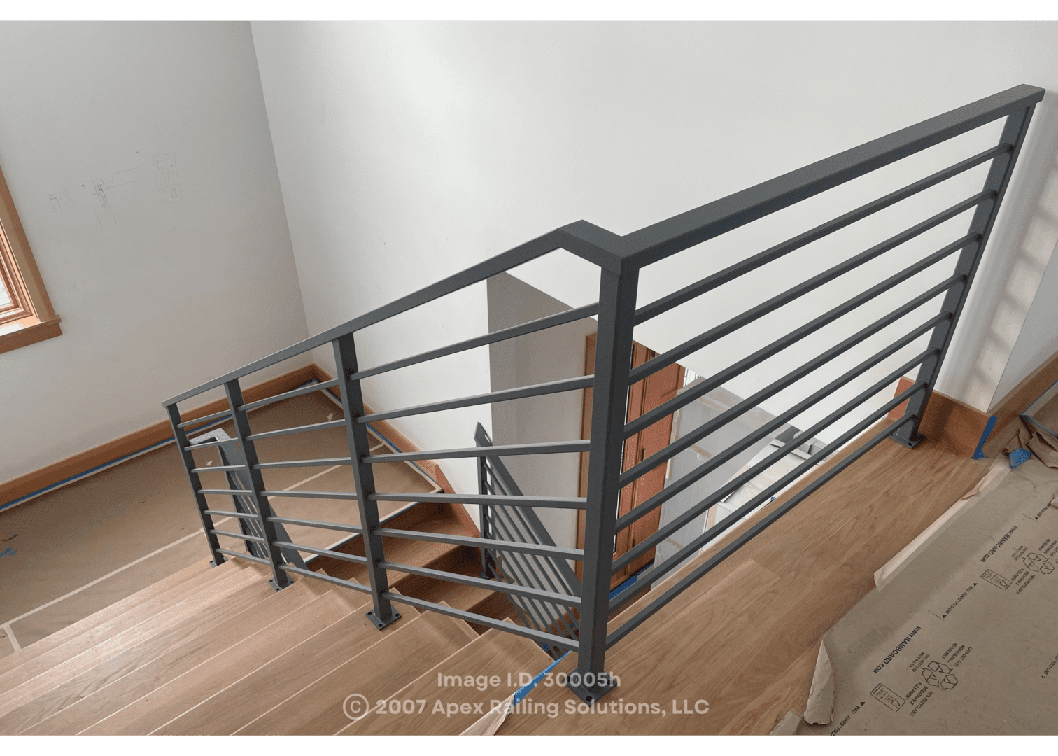 Custom staircase railing on the interior of a home made with fabricated metal